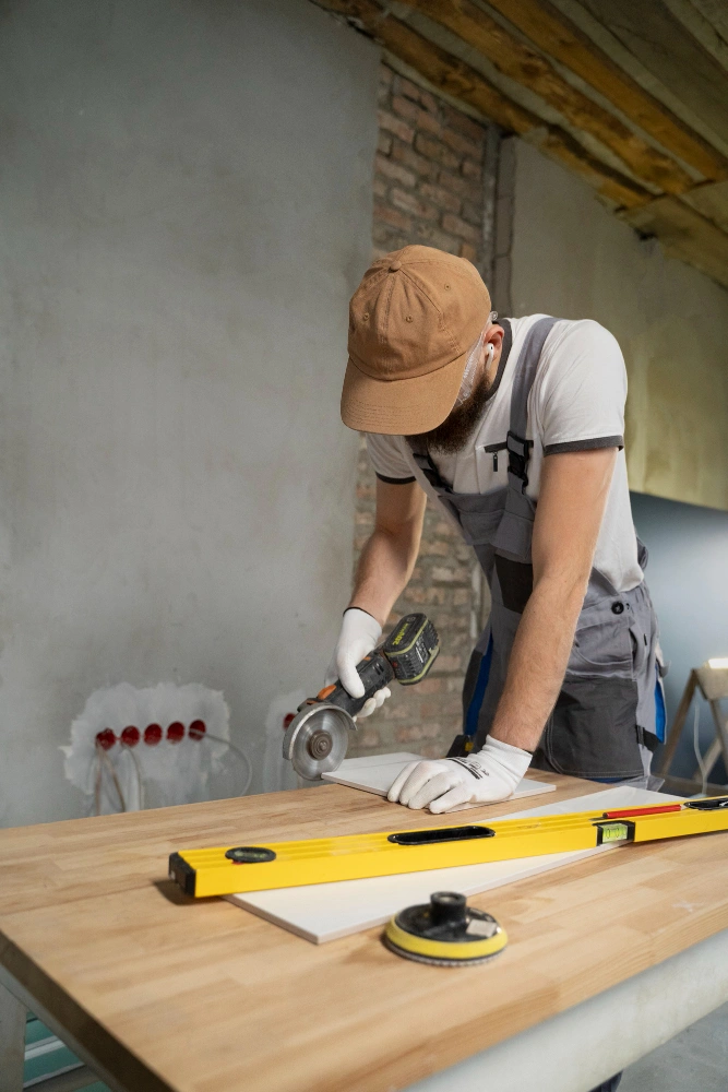 Man using circular saw on wood with gloves and level, demonstrating cutting fire components safely.