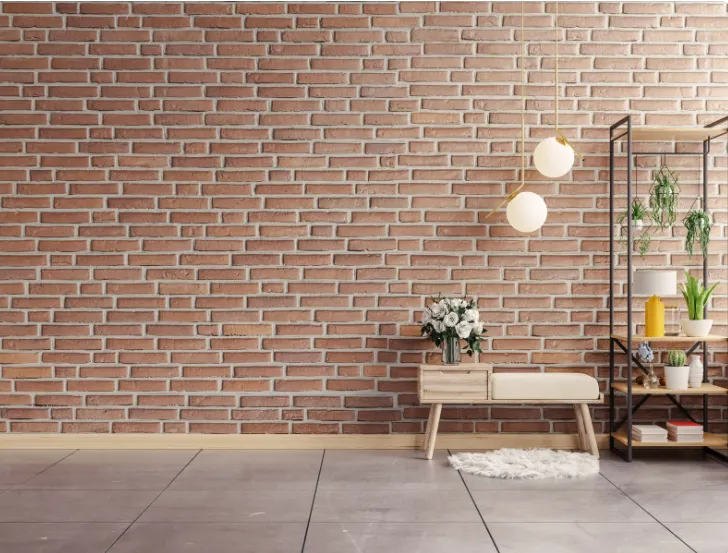 Cozy interior with textured brick wall, wooden bench, potted flowers, and modern hanging lights showcasing smooth finishing.