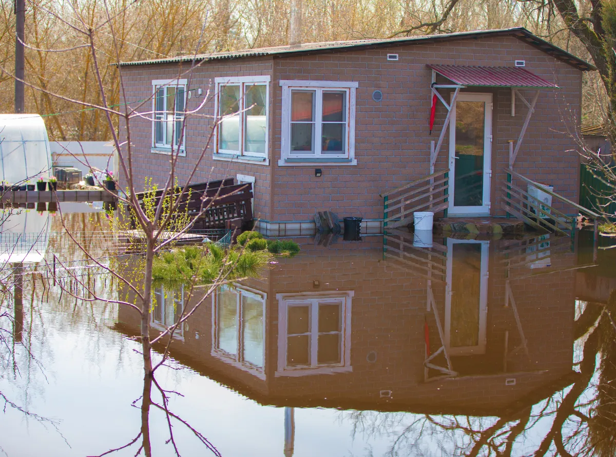 House surrounded by floodwater illustrating different types of flood and water damage.