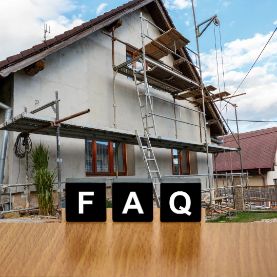 FAQ blocks in front of a home remodeling exterior with scaffolding and renovation work in progress